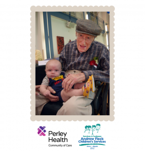 Picture of elderly man holding baby.