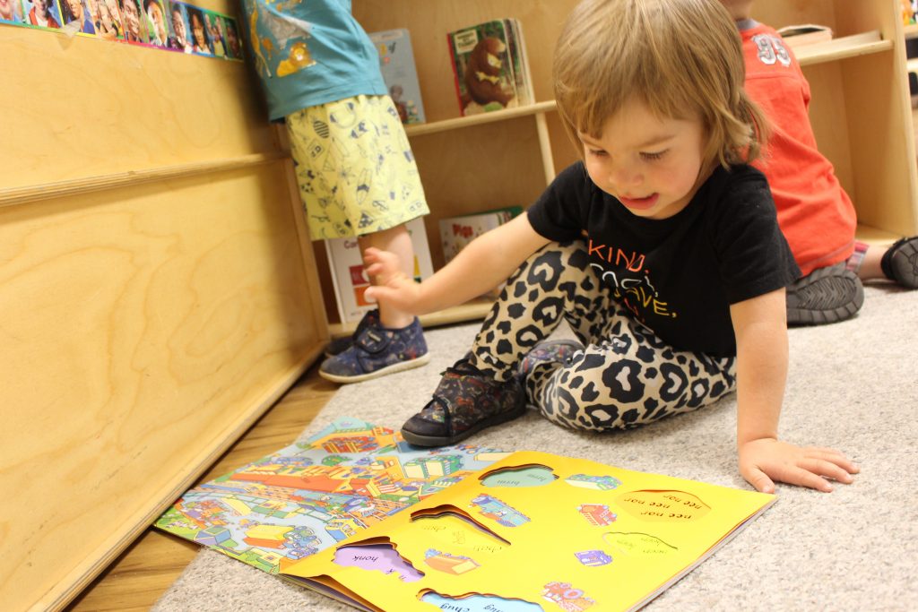 Child playing with book.