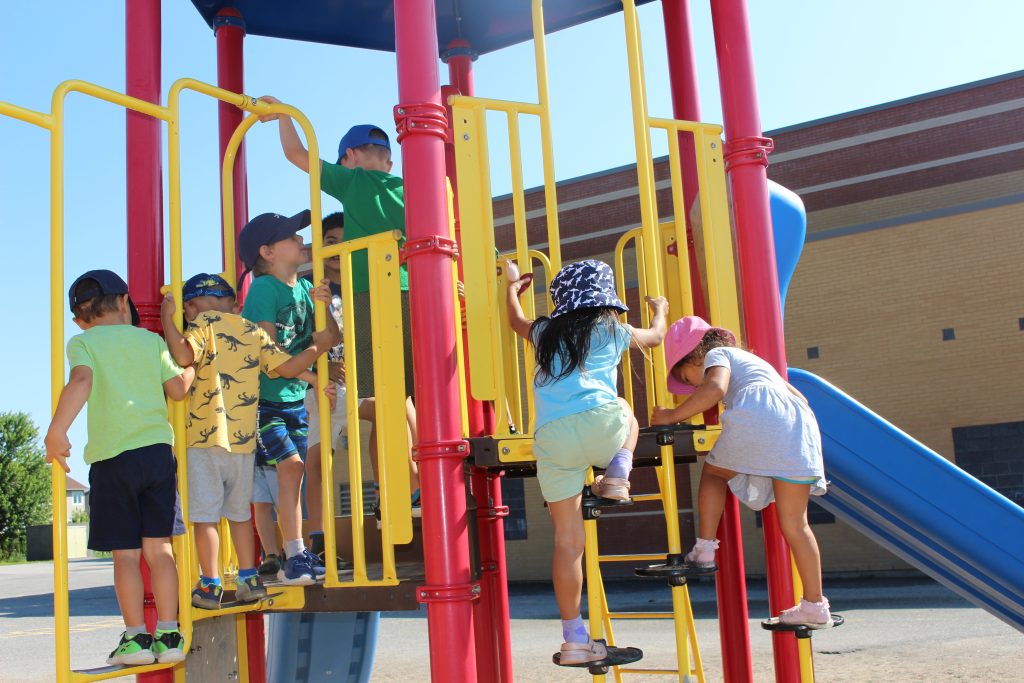 Kids playing on playground structure.